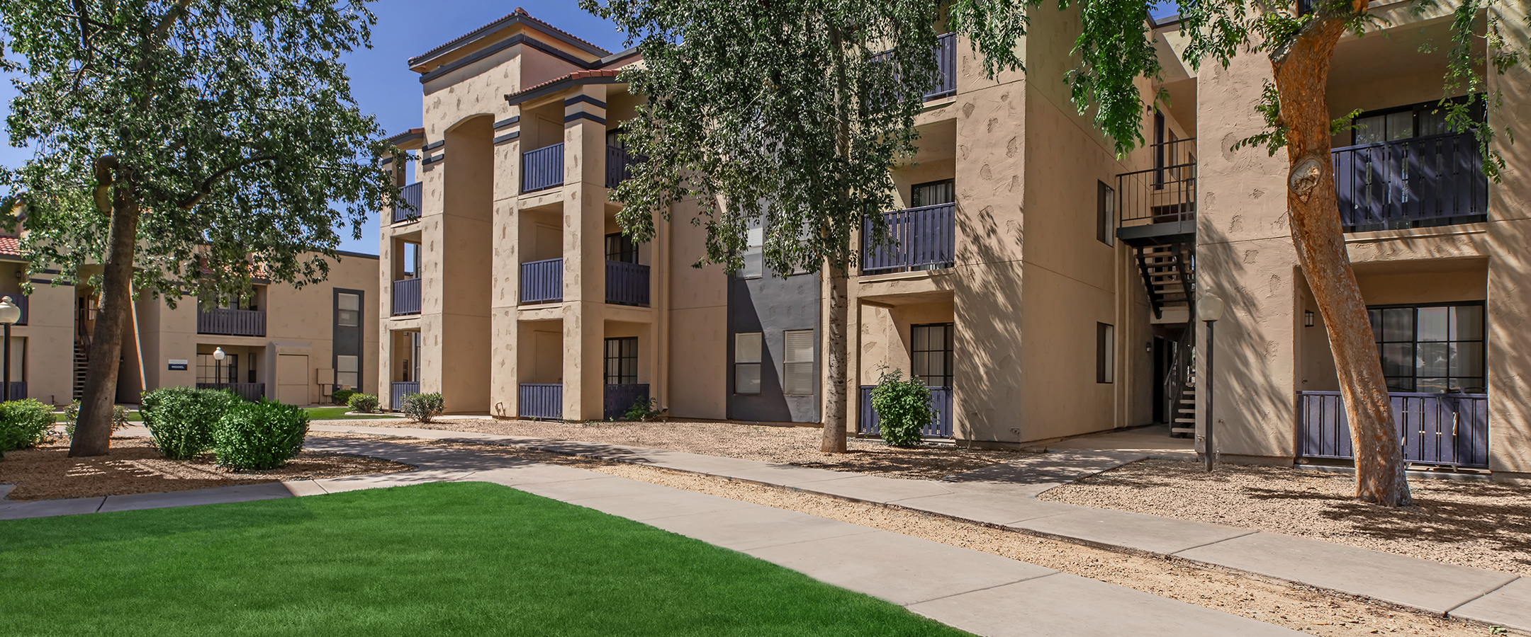 Apartments in Phoenix, AZ - Monaco31 Spacious Living Room with Wood-Style Flooring and Large Sliding Glass Door with Patio Access